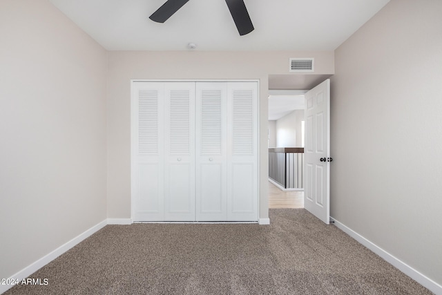 unfurnished bedroom with a closet, carpet flooring, and ceiling fan