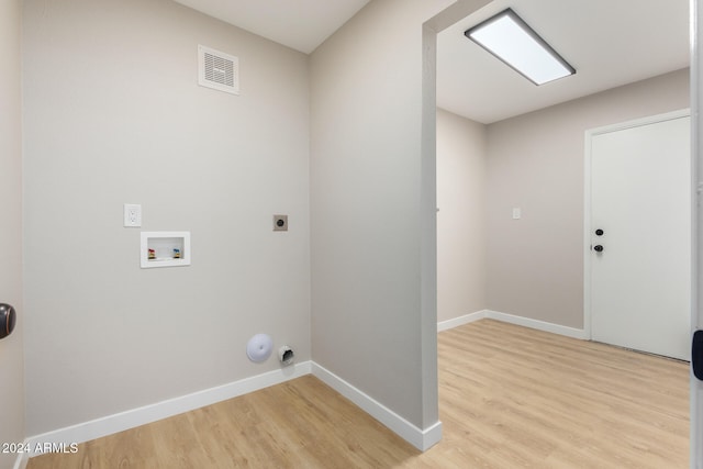 washroom featuring washer hookup, light hardwood / wood-style flooring, and electric dryer hookup