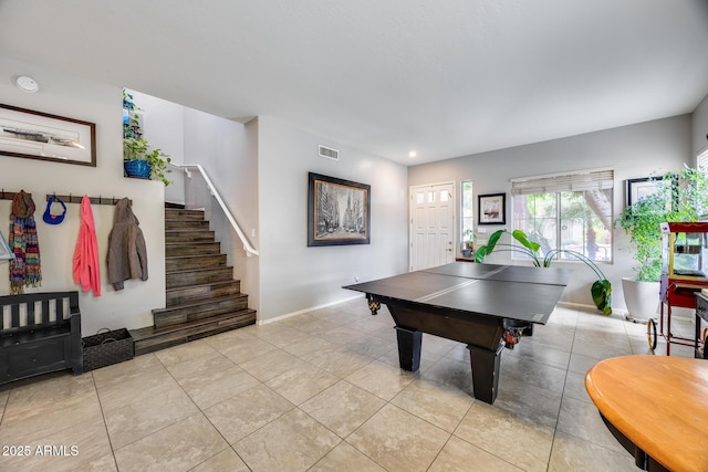 game room featuring baseboards and light tile patterned floors