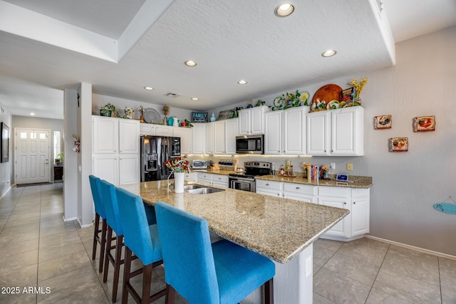 kitchen featuring stainless steel appliances, baseboards, light tile patterned flooring, recessed lighting, and white cabinets