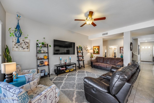 living room with a ceiling fan and tile patterned flooring