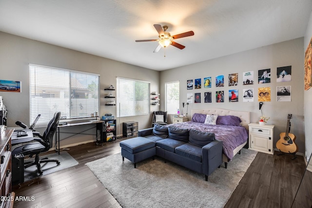 bedroom with a desk, dark wood-style flooring, baseboards, and a ceiling fan