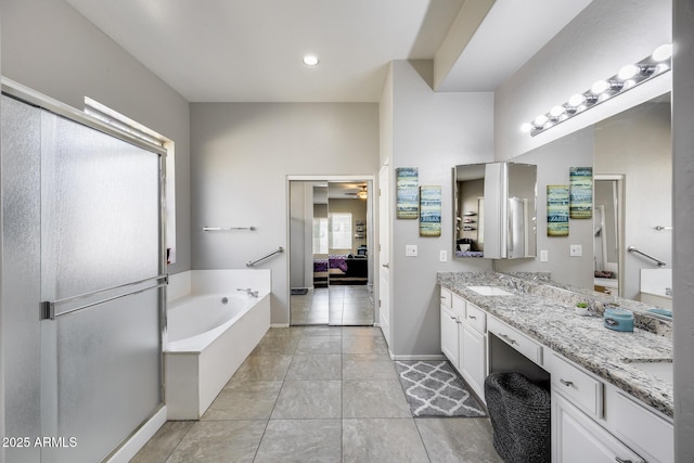 bathroom featuring ensuite bath, a bath, vanity, a ceiling fan, and tile patterned floors