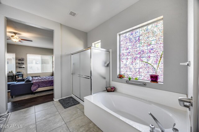 full bathroom featuring connected bathroom, a shower stall, a bath, and plenty of natural light