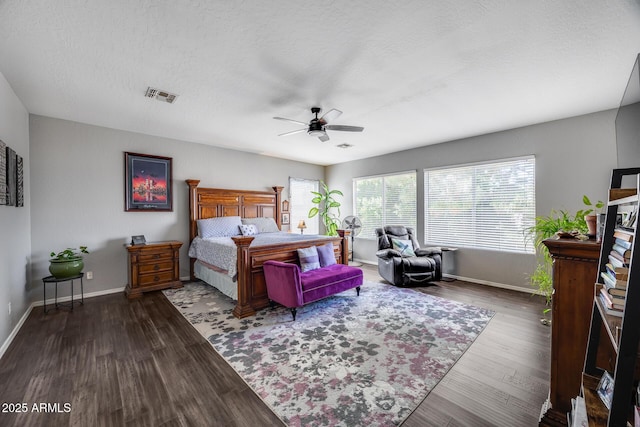 bedroom with baseboards, wood finished floors, ceiling fan, and a textured ceiling