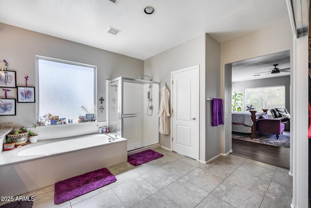 bathroom with ensuite bathroom, a garden tub, a stall shower, ceiling fan, and tile patterned floors