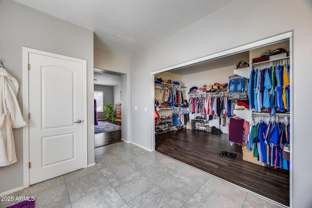 spacious closet with tile patterned floors