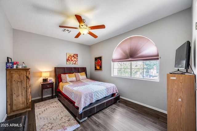 bedroom with wood finished floors, baseboards, and ceiling fan