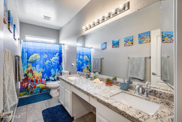 full bathroom with toilet, tile patterned floors, a shower with curtain, double vanity, and a textured ceiling