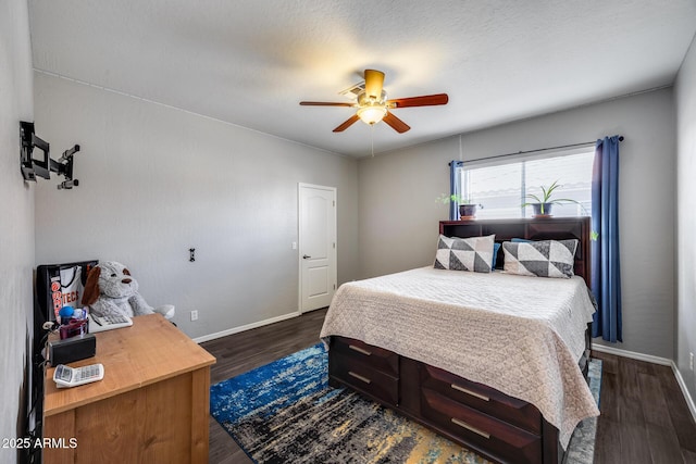 bedroom with dark wood-style flooring, baseboards, and ceiling fan