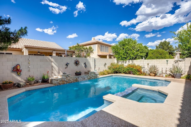 view of swimming pool with a fenced backyard and a pool with connected hot tub