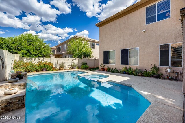 view of pool with a fenced backyard, a pool with connected hot tub, and a patio area