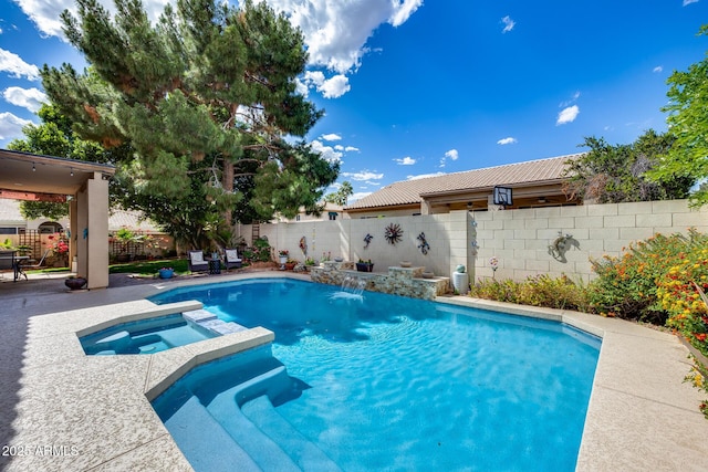 view of pool featuring a patio area, a fenced backyard, and a pool with connected hot tub