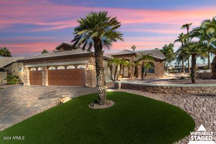 view of front of home featuring a lawn and a garage