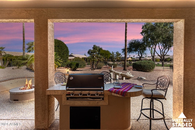 3507 N Snead Dr, Goodyear, AZ 85395 - patio terrace at dusk featuring a fire pit and a patio