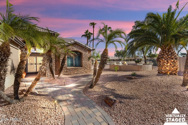 3507 N Snead Dr, Goodyear, AZ 85395 - view of front of home featuring stone siding and a tiled roof