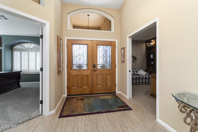 3507 N Snead Dr, Goodyear, AZ 85395 - entrance foyer with baseboards, a high ceiling, and wood finished floors