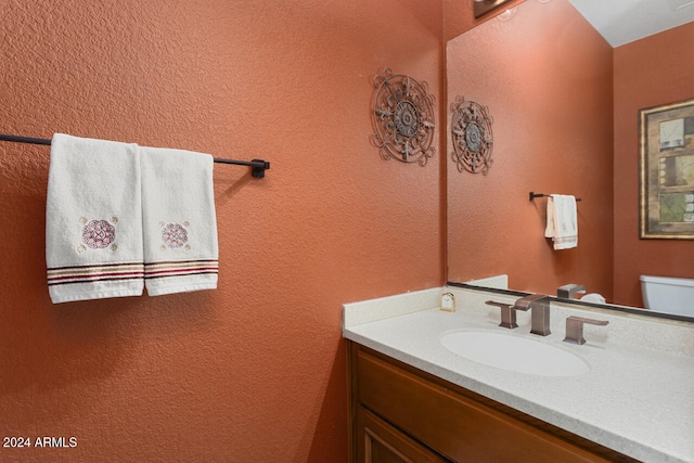 3507 N Snead Dr, Goodyear, AZ 85395 - bathroom featuring vanity, toilet, and a textured wall