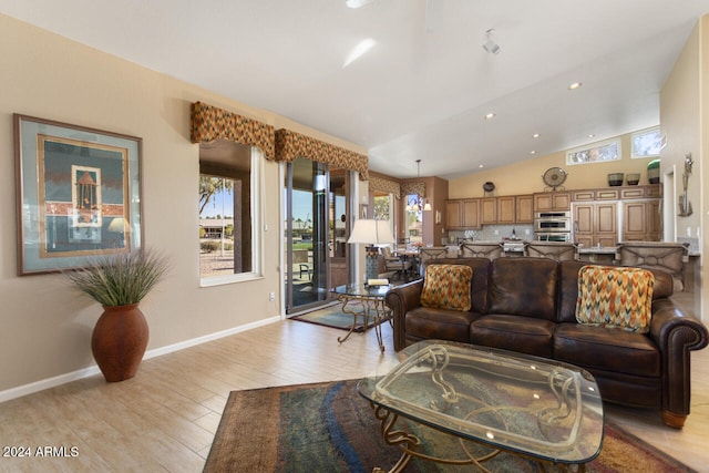 3507 N Snead Dr, Goodyear, AZ 85395 - living room with light wood-type flooring, vaulted ceiling, baseboards, and recessed lighting