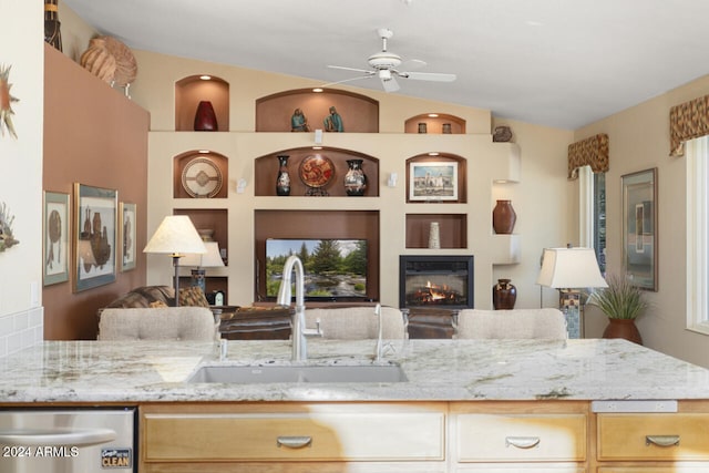 3507 N Snead Dr, Goodyear, AZ 85395 - kitchen with a sink, open floor plan, dishwasher, a ceiling fan, and light stone counters