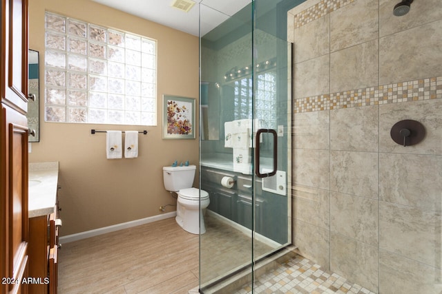 3507 N Snead Dr, Goodyear, AZ 85395 - bathroom featuring vanity, a stall shower, toilet, baseboards, and wood finished floors