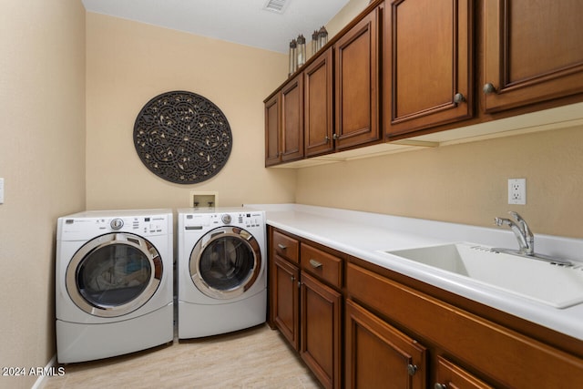 3507 N Snead Dr, Goodyear, AZ 85395 - washroom with cabinet space, independent washer and dryer, and light wood-style flooring