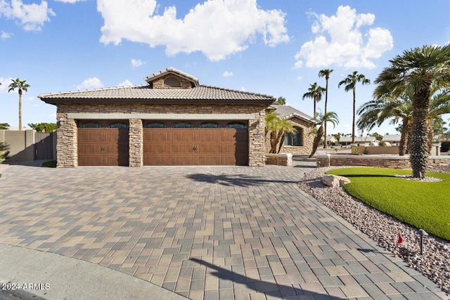 3507 N Snead Dr, Goodyear, AZ 85395 - view of front of property featuring stone siding, a tile roof, an attached garage, and decorative driveway