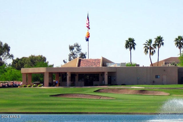 view of home's community featuring a water view and a lawn