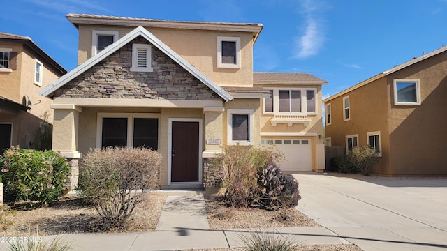 view of front of house with a tile roof, stucco siding, an attached garage, stone siding, and driveway