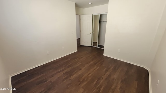 35005 N 30th Dr, Phoenix, AZ 85086 - unfurnished bedroom with a closet, baseboards, and dark wood-type flooring
