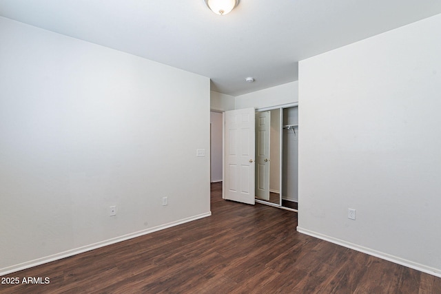 35005 N 30th Dr, Phoenix, AZ 85086 - unfurnished bedroom featuring a closet, baseboards, and dark wood-style flooring