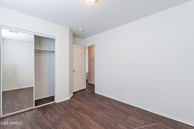 35005 N 30th Dr, Phoenix, AZ 85086 - unfurnished bedroom with visible vents, baseboards, a closet, and wood finished floors