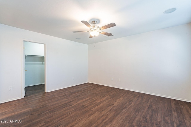 35005 N 30th Dr, Phoenix, AZ 85086 - unfurnished bedroom with a walk in closet, baseboards, ceiling fan, dark wood finished floors, and a closet