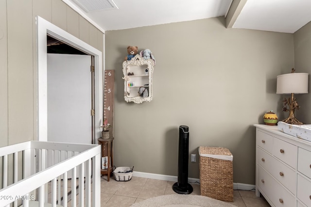 bedroom with a nursery area, light tile patterned flooring, visible vents, and baseboards