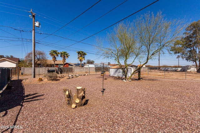 view of yard with an outbuilding and fence