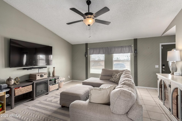 living room featuring light tile patterned floors, a ceiling fan, wallpapered walls, vaulted ceiling, and a textured ceiling