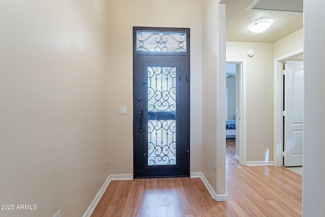 foyer entrance with light wood-type flooring