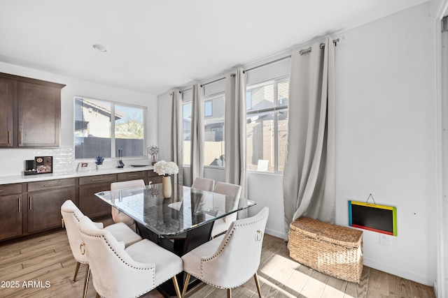 dining room featuring a healthy amount of sunlight and light wood-type flooring