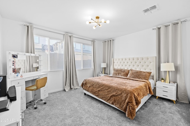 carpeted bedroom featuring an inviting chandelier