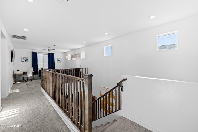 hallway featuring light carpet