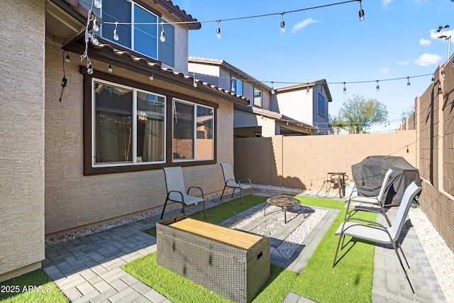 view of patio / terrace featuring a grill and a fire pit