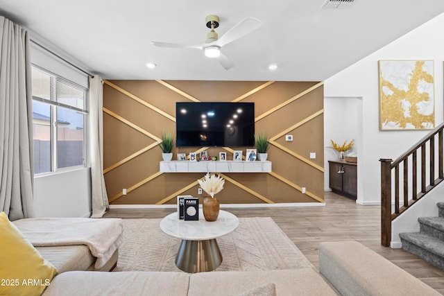 living room with hardwood / wood-style flooring and ceiling fan