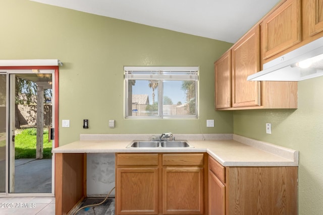 kitchen with lofted ceiling, sink, and light tile patterned floors