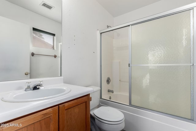 full bathroom featuring enclosed tub / shower combo, vanity, and toilet