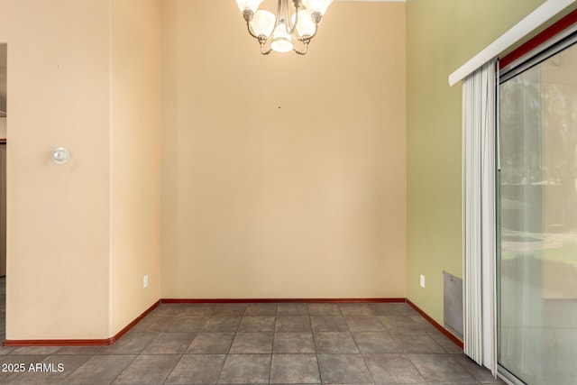 empty room featuring a chandelier