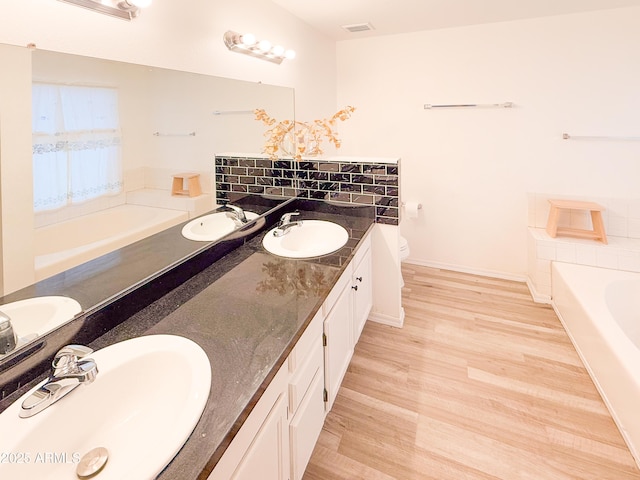 full bathroom with a bath, visible vents, and a sink