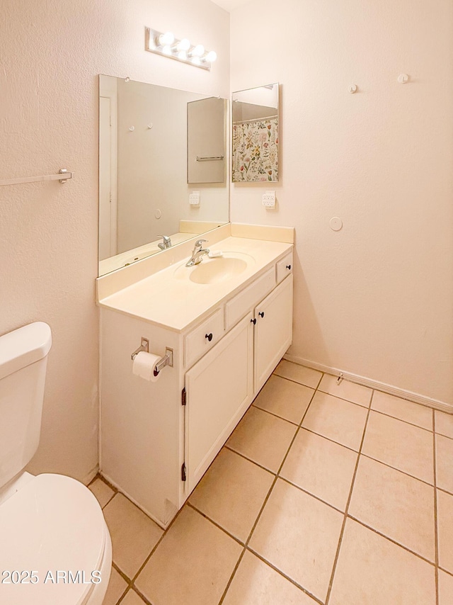 bathroom featuring tile patterned floors, toilet, and vanity