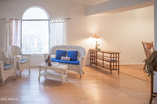 sitting room featuring baseboards and wood finished floors