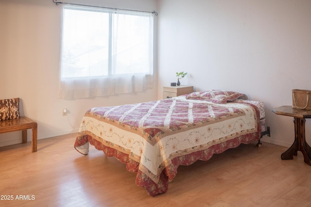 bedroom with wood finished floors and baseboards