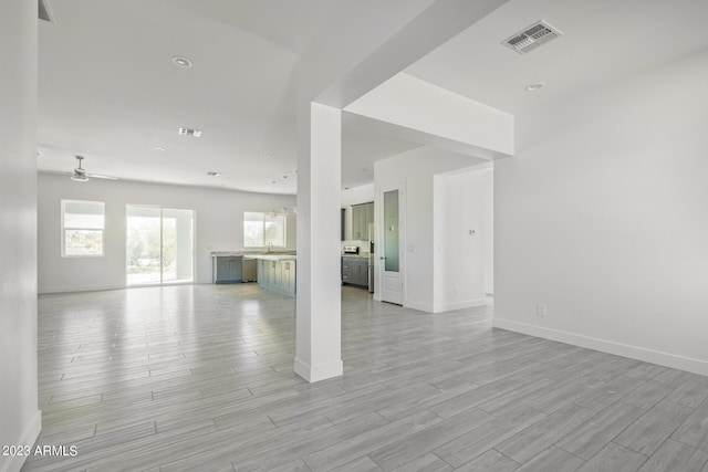 unfurnished living room with ceiling fan